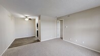 Located at 415 NE Delaware Ave in Ankeny, Iowa, this one-bedroom, one-bathroom unit offers a well-organized, single-floor layout designed for comfortable everyday living. The living room serves as the heart of the space, featuring soft wall-to-wall carpeting, neutral beige walls, and a textured ceiling. A ceiling fan provides overhead lighting and air circulation, while the transition to wood-style flooring in the adjacent area adds a subtle contrast in materials and defines the space naturally.

The bedroom is a comfortably sized retreat with plush carpeting, neutral tones, and a large window that invites natural light and provides views of the surrounding exterior. White trim and clean lines throughout contribute to a bright, cohesive aesthetic. A dedicated closet offers convenient storage directly off the bedroom.

The bathroom is straightforward and functional, featuring a full-size soaking tub with a tub/shower surround, a toilet, and wood-style flooring that complements the rest of the unit. The clean white fixtures stand out against the neutral wall tones, creating a tidy and practical space.

Overall, the unit maintains a consistent palette of warm neutrals and clean whites, offering a move-in-ready environment that is easy to personalize. The efficient layout makes practical use of every area, making this a solid and well-appointed living space in Ankeny.