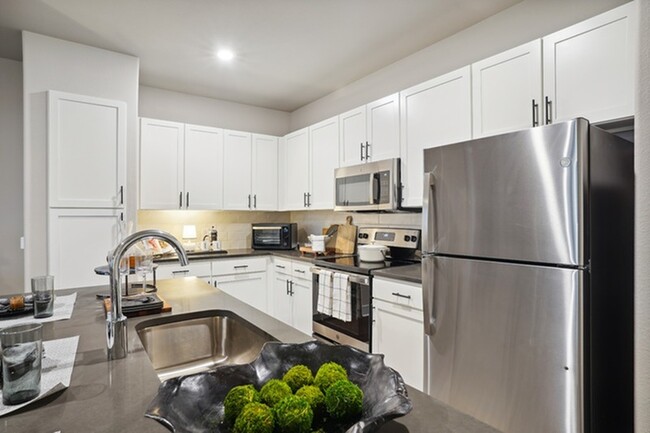 Luxe kitchen with stainless steel appliances and large island - Lakeview at the Gates of Prosper