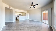 Located at 8120 Mainland Dr in San Antonio, Texas, this single-floor residence offers a practical and comfortable layout with two bedrooms and two full bathrooms. The open living area is bright and welcoming, featuring wood-look laminate flooring, neutral gray walls, and a ceiling fan that enhances airflow throughout the space. Large windows and a sliding glass door flood the room with natural light and provide direct access to a private patio with outdoor views.

The kitchen is designed for functionality, featuring white cabinetry, stone-look countertops, stainless steel appliances including a refrigerator and electric range, a double-basin sink, and a pass-through counter that connects seamlessly to the living area. A dedicated in-unit laundry area adds everyday convenience.

Both bedrooms are carpeted for comfort, each equipped with a ceiling fan, generous closet space with bifold doors, and ample room for furnishings. The primary bedroom is well-proportioned, offering its own access to a full bathroom. The bathrooms are finished with wood-look flooring, stone-look countertops, white cabinetry, and tub-shower combinations. A hallway connects the key areas of the home, contributing to a cohesive and efficient floor plan throughout.