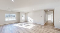 Located at 9000 Lyla Way in Bordentown, NJ, this well-appointed single-floor home offers three bedrooms and three full bathrooms thoughtfully arranged for comfort and functionality. The open-concept living and kitchen area serves as the heart of the home, featuring light-toned wood-look flooring throughout, recessed lighting, and large windows that invite abundant natural light. The kitchen is outfitted with light wood cabinetry, white quartz countertops, a kitchen island, stainless steel gas range, and built-in microwave — a clean, modern aesthetic ideal for everyday living and entertaining. The spacious primary bedroom includes a sliding glass door opening to a private balcony with outdoor views, vertical blinds, and generous room dimensions. Additional bedrooms are bright and airy, each benefiting from large windows and the same warm wood-look flooring. The bathrooms are finished with neutral large-format tile flooring, and at least one features a soaking tub with stylish stacked stone-look tile surround. A dedicated closet provides additional storage. The overall ambiance is clean, bright, and contemporary, with a neutral color palette that creates a calm and welcoming atmosphere throughout.