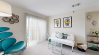 Located at 12598 W Dakota Ave in Lakewood, Colorado, this one-bedroom, one-bathroom residence offers a thoughtfully designed single-floor layout that maximizes every square foot. The living room is bright and open, featuring plush carpeting, large vertical-blind-covered sliding doors that invite natural light, and enough space to accommodate a comfortable seating arrangement. An adjoining area connects seamlessly to the kitchen, which is equipped with stainless steel appliances — including a range, microwave, and refrigerator — complemented by gray cabinetry and a light granite-style countertop that extends into a breakfast bar. Light wood-style flooring runs through the kitchen and dining area, adding warmth and continuity. The bedroom offers a cozy, carpeted retreat with generous closet space, including a wide double sliding-door closet that provides ample storage. The bathroom features light wood-style flooring, a gray vanity with stone-pattern countertop, and a shower-tub combination. A dedicated laundry area adds everyday convenience. Throughout the residence, neutral wall tones provide a clean, versatile backdrop, and the consistent design aesthetic ties each room together cohesively.