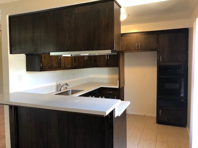 Kitchen with quartz tops, cooktop, wall oven, dishwasher - 11168 Acama St