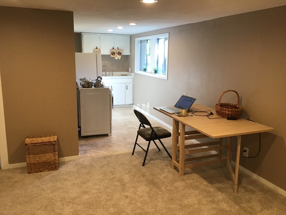 Work table and kitchen. - 17405 Ashworth Ave N