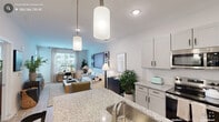 This thoughtfully designed one-bedroom, one-bathroom residence in Durham, NC offers a well-appointed open-concept layout that maximizes every square foot. The kitchen is a standout feature, showcasing granite countertops, crisp white shaker cabinetry with matte black hardware, a central island with pendant lighting overhead, and a full suite of stainless steel appliances including a French door refrigerator, electric range, and built-in microwave. Light wood-style flooring flows seamlessly from the kitchen into the living area, which is bathed in natural light from large windows with views of the surrounding neighborhood. The living room provides a comfortable and versatile space, well-suited for both relaxation and a dedicated workspace. The bedroom is generously proportioned, featuring a ceiling fan, large windows with blinds and sheer curtains, and a closet. The bathroom continues the home's refined aesthetic with granite-topped vanity cabinetry, a large mirror, and modern fixtures. A hallway with additional storage completes the floorplan. Throughout the residence, neutral tones, recessed lighting, and consistent finishes create a clean, modern ambiance that is both functional and inviting.