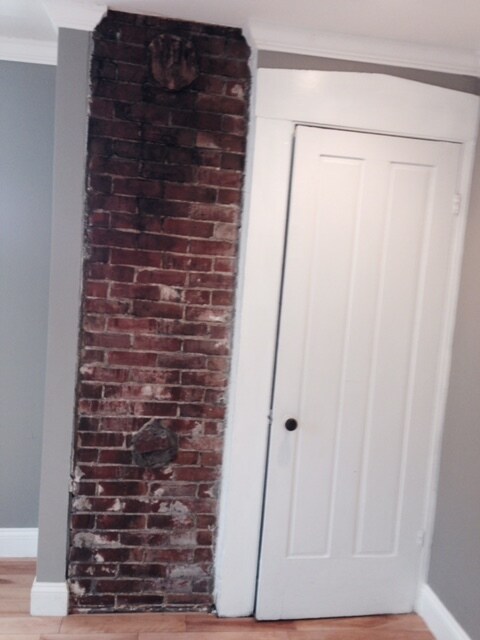 Exposed brick with closet in the living space - 282 Brackett Street