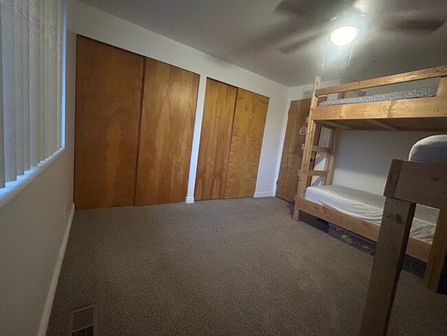 SE bdrm. Beautiful fall wallpaper. Double closet. Ceiling fan. - 3780 W Montana St