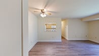 Located at 102 Waldon Rd in Abingdon, Maryland, this single-floor, 2-bedroom, 3-bathroom home offers a practical and well-appointed layout. Throughout the living areas and bedrooms, durable hardwood-style laminate flooring in a warm gray tone creates a cohesive and clean aesthetic. The living room is bright and open, anchored by a sliding glass door that invites natural light and provides direct views of the surrounding greenery. A ceiling fan adds comfort to this central gathering space, which flows conveniently into the kitchen via a pass-through window. The kitchen features warm oak cabinetry with ample storage, laminate countertops, and a full suite of appliances including a gas range and over-the-range microwave. Each bedroom includes closet space and windows that bring in natural light with views of the outdoors. The primary bedroom offers a generous footprint with a dedicated closet. The three bathrooms are well-maintained, each featuring light oak vanities with white countertops and tile-surround tub and shower combinations finished with classic white subway tile. Tile flooring completes the bathrooms. A connecting hallway ties the rooms together efficiently, making the most of the home's compact yet functional floor plan.