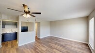 Located at 3708 Garden Oaks Dr in New Orleans, LA, this single-story, 3-bedroom, 1-bathroom home offers a practical and well-organized layout. The combined kitchen and living area serves as the heart of the home, featuring wood-look plank flooring, neutral-toned walls, and a ceiling fan with light fixture. The kitchen is equipped with dark cabinetry, marble-look countertops, and stainless steel appliances, including a full-size refrigerator. A half-wall partition visually separates the kitchen from the open living space.

The three bedrooms are carpeted and share a consistent neutral color palette, each featuring windows with blinds that allow natural light and outdoor views. The primary bedroom includes dual windows overlooking the surrounding greenery, while the additional bedrooms each offer a window and built-in closet storage. White six-panel doors are used consistently throughout, adding a clean, cohesive aesthetic.

A central hallway connects the bedrooms to the shared bathroom, which includes a soaking tub, toilet, and vanity with a marble-look countertop. The bathroom features wood-look flooring that ties into the rest of the home. Overall, the space maintains a clean, move-in-ready feel with a neutral, functional design throughout.