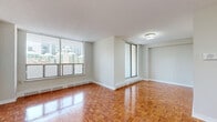 Located on the 9th floor at 565 Sherbourne Street in Toronto, this three-bedroom, one-bathroom unit offers a well-organized layout with consistent parquet flooring flowing throughout every room, lending warmth and character to the space.

The open living area is a highlight, featuring large floor-to-ceiling windows that frame sweeping city skyline views and fill the space with abundant natural light. Baseboard heating runs along the perimeter of the main rooms, ensuring comfort year-round. A private balcony with exposed brick accents provides direct outdoor access and additional views of the surrounding neighbourhood.

The kitchen is equipped with white cabinetry, marble-patterned countertops, a stainless steel refrigerator, a double sink, and tile flooring — a practical and clean workspace. The three bedrooms are well-proportioned, with the primary bedroom offering generous closet space via sliding-door built-ins. The additional bedrooms also feature sliding-door closets and city-facing windows. The bathroom is finished with white tile surround and includes a full soaker tub with shower.

A hallway entry connects all rooms efficiently, completing a functional and comfortable layout in the heart of Toronto's St. James Town neighbourhood.