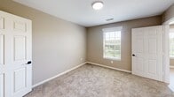 Located at 1900 Switzer Rd in Gulfport, Mississippi, this single-floor, 2-bedroom, 2-bathroom home offers a practical and comfortable layout with consistent, neutral design throughout. The warm beige walls and white trim create a clean, cohesive aesthetic that flows from room to room.

Both bedrooms feature plush wall-to-wall carpeting and windows with blinds that allow for natural light while maintaining privacy. The primary bedroom is a well-proportioned retreat with direct access to a dedicated closet, as well as a walk-in closet outfitted with wire shelving and carpeted flooring — providing generous storage capacity. A ceiling fan is also visible in the living area, contributing to year-round comfort.

Each bathroom is finished with light wood-look luxury vinyl plank flooring, white cabinetry with marble-style countertops, and a tub-shower combo. One bathroom features a bold-framed mirror above the vanity, adding a touch of style to the otherwise clean and functional space.

The floor plan, visible in the dollhouse view, reveals an open-concept living and kitchen area with light flooring that connects seamlessly to the hallways leading to the bedrooms. The layout makes efficient use of space, with two hallways ensuring smooth circulation throughout the home. Overall, the residence presents a move-in-ready interior with a neutral palette suited to a variety of personal styles.