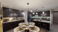 Located in Houston, TX, this single-floor residence showcases a thoughtfully designed interior that blends modern sophistication with everyday comfort. The open-concept kitchen is a standout feature, outfitted with rich dark espresso cabinetry, granite countertops, a subway tile backsplash, and a full suite of stainless steel appliances. A large center island with bar seating offers additional prep space and casual dining, while pendant lighting adds a refined finishing touch. Adjacent to the kitchen, the dining area accommodates a round table with upholstered seating beneath a striking multi-bulb chandelier, creating an inviting atmosphere for meals and gatherings. The living room is anchored by a bold patterned accent wall with decorative wall sconces and flows effortlessly to a private balcony through floor-to-ceiling sliding glass doors, filling the space with natural light and outdoor views. Wide-plank hardwood-style flooring runs throughout the main living areas. The bedroom is a serene retreat with plush carpeting, a tray ceiling, built-in shelving, and a private balcony access. The bathroom features large-format tile flooring, dark vanity cabinetry with granite countertops, a framed mirror, and a soaking tub, completing this well-appointed residence.