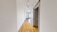 This 490 square foot apartment in Dallas, TX offers a thoughtful blend of comfort and functionality. The single-floor layout comprises one bedroom, one bathroom, a kitchen, and a hallway, maximizing every inch of space. The primary bedroom, measuring 140 square feet, features plush carpeting, a ceiling fan, and ample natural light from a window.

The kitchen stands out with its modern design, boasting rich wood cabinetry, stainless steel appliances, and a striking mosaic tile backsplash. The space is further enhanced by gleaming hardwood floors and a convenient breakfast bar. Track lighting and large windows contribute to the bright, open feel of the area.

The bathroom continues the contemporary theme with elegant tile work, a spacious vanity, and a combination tub-shower. Throughout the apartment, neutral wall colors and recessed lighting create a sense of spaciousness. The overall design emphasizes clean lines and efficient use of space, making it an ideal choice for those seeking a stylish yet compact urban dwelling.