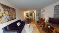 This single-floor unit in Baton Rouge, Louisiana, offers a thoughtfully organized layout that maximizes its footprint. The open living and dining area serves as the heart of the space, featuring wood-style flooring that runs throughout and a textured ceiling. A window at the far end of the living area allows natural light to filter in, complementing the neutral wall tones and creating a welcoming atmosphere.

The galley-style kitchen is efficiently designed, featuring rich dark cabinetry, granite-style countertops, and black appliances including a refrigerator, electric range, and built-in microwave. A stainless steel sink is positioned along one wall, maximizing counter workspace on both sides.

The bedroom is carpeted and comfortably sized, offering two bifold closets that provide ample storage. A window dressed with sheer curtains brings in natural light, enhancing the room's calm, restful character.

The bathroom includes a single-sink vanity with dark wood cabinetry, a large mirror, and a shower-tub combination. A utility closet near the bathroom houses the HVAC unit, keeping mechanical systems neatly contained within the floor plan.
