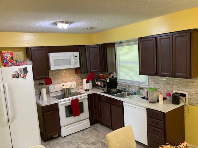 Large kitchen with door to backyard. - 7700 Midwood Dr