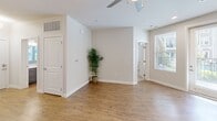 Located at 1325 Boland Pl in Richmond Heights, MO, this well-appointed one-bedroom, one-bathroom unit offers a thoughtfully designed single-floor layout with a clean, modern aesthetic. The open-concept living area features warm wood-look flooring, neutral tones, and a ceiling fan, creating a bright and airy atmosphere with natural light streaming through large windows.

The kitchen is a standout feature, showcasing gray shaker-style cabinetry, gleaming light stone countertops, and a full suite of stainless steel appliances including a refrigerator, range, and built-in microwave. A central island with a built-in sink, pendant lighting, and bar seating makes it ideal for both cooking and casual dining.

The bedroom is carpeted for comfort and includes a ceiling fan, ample natural light from dual windows, and access to a private outdoor area. The bathroom continues the cohesive design with gray cabinetry, stone countertops, a large vanity mirror, and warm wood-look flooring. A dedicated in-unit laundry room with full-size washer and dryer adds exceptional everyday convenience. Overall, the space combines functional living with contemporary style in a compact and efficient footprint.