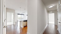 Located at 480 N Orange Ave in the heart of downtown Orlando, this well-appointed 3-bedroom, 2-bathroom residence offers a thoughtfully designed single-floor layout with modern finishes throughout. The open-concept living and kitchen area is anchored by rich hardwood flooring, track lighting, and large sliding glass doors that invite natural light and provide views of the surrounding cityscape. The kitchen is a standout feature, boasting white shaker cabinetry, dark granite countertops, a mosaic tile backsplash, stainless steel appliances including a refrigerator, microwave, and range, and a central island with pendant lighting overhead — ideal for both cooking and casual dining. The three bedrooms are carpeted for comfort, each offering ceiling fans and windows with urban views. The spacious primary bedroom connects to a well-organized walk-in closet with built-in shelving and a private en-suite bathroom featuring a glass-enclosed shower, granite vanity, and large-format tile flooring. The second bathroom mirrors this quality with a soaking tub, tiled surround, and granite countertop vanity. Two closets provide ample storage throughout the residence, completing this polished urban home.
