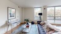 Located at 3333 Wisconsin Ave NW in Washington, DC, this well-appointed two-bedroom, two-bathroom residence offers a thoughtfully designed single-floor layout with a clean, modern aesthetic. The open-concept living area features warm hardwood flooring, large windows that bring in abundant natural light, and a bright, neutral color palette that creates an inviting atmosphere throughout.

The kitchen is a functional centerpiece, showcasing light maple cabinetry, dark granite countertops, stainless steel appliances, and a peninsula with bar seating — ideal for casual dining or entertaining. It flows seamlessly into the living room, which offers generous space and outdoor views through corner windows.

Both bedrooms are carpeted for comfort and feature natural light from large windows with views of the surrounding neighborhood. The primary bedroom is comfortably sized and includes access to a closet. The two bathrooms differ in design: one features a pedestal sink, white subway tile, and a walk-in shower with decorative tile accents, while the second offers a wood-toned vanity with granite countertops and tile flooring.

A dedicated closet provides additional storage, rounding out this well-organized and efficiently laid-out residence in one of Washington, DC's desirable Northwest neighborhoods.