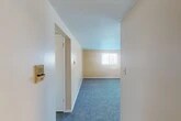 Located at 128 Polk St in Syracuse, NY, this two-bedroom, one-bathroom unit offers a practical and well-organized single-floor layout. The space is thoughtfully arranged to maximize functionality, featuring a dedicated entrance, a hallway connecting the main areas, and three closets providing ample storage throughout.

The spacious primary bedroom is a standout feature, boasting plush gray carpeting, warm neutral walls, and two windows fitted with blinds that allow natural light to fill the room. A baseboard heating unit ensures year-round comfort. The second bedroom is similarly appointed with soft carpeting, a window with blinds, and an adjacent closet, making it a versatile space for guests or a home office.

The kitchen features warm wood cabinetry, open shelving, light countertops, and a double-basin sink beneath a window. A coil-top electric range with an overhead exhaust hood completes the setup, all set on easy-care hard flooring.

The bathroom includes tile flooring, a toilet, and a vanity mirror with a wood-framed surround, with direct access to the carpeted hallway. Throughout the unit, a consistent palette of warm beige tones and white trim creates a cohesive and inviting atmosphere, making this a functional and comfortable home.