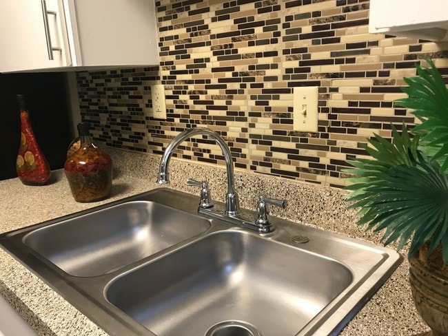 stainless steel sinks & faux tile - Sun Colony Apartments