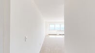 Located along the Jersey Shore at 385 Ocean Blvd in Long Branch, NJ, this one-bedroom, one-bathroom residence offers a well-organized layout across a single floor. The living room is a standout space, bathed in natural light streaming through a wide bank of windows that frame breathtaking, unobstructed views of the Atlantic Ocean. Plush wall-to-wall carpeting and clean white walls create a bright, airy atmosphere throughout. The kitchen is thoughtfully equipped with warm honey-toned wood cabinetry, granite-style countertops with a tile backsplash, and black appliances including a gas range, dishwasher, and refrigerator. Light tile flooring grounds the kitchen area, which flows seamlessly into the living space. The generously sized bedroom features soft carpeting, crisp white walls, and a double set of closets providing ample storage. The bathroom is finished with classic beige tile surrounds accented by decorative mosaic border strips, and includes a full soaking tub with a shower. The building's brick exterior and private balcony further enhance the coastal living experience, making this an ideal oceanfront retreat.