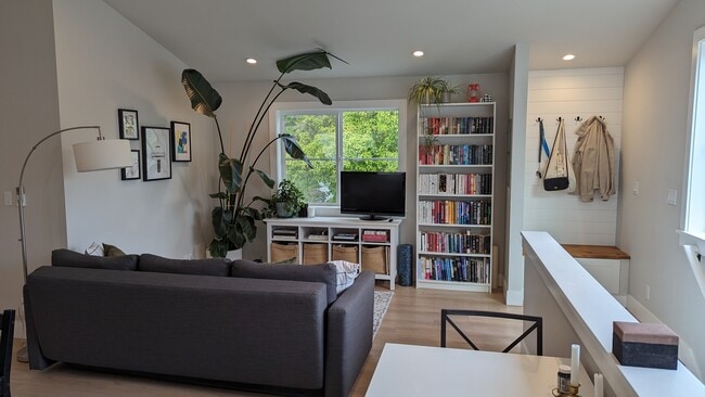 Living room with great natural light and view of trees - 3240 29th Ave W