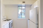 Located at 3511 Briarwood Drive in Dumfries, VA, this one-bedroom, one-bathroom residence offers a well-organized, efficient layout across a single floor. The living room features warm light wood flooring, neutral gray walls, and clean white trim, creating a bright and welcoming atmosphere. The kitchen is equipped with a gas range, white cabinetry, and elegant marble-style countertops that add a refined touch to the space. The spacious primary bedroom is carpeted for comfort and includes generous closet space with double bi-fold doors, providing ample storage. The bathroom is finished in an all-white palette, complete with a combined tub and shower, a white vanity with cabinet storage, and light wood-style flooring that ties into the overall aesthetic of the home. Additional conveniences include a dedicated laundry area and a closet. The neutral color scheme and clean finishes throughout the unit create a cohesive and move-in-ready environment. The doll-house view reveals mature trees surrounding the building, adding a natural, serene backdrop to the property's setting.