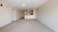Located at 2000 NE Coronado Dr in Blue Springs, MO, this one-bedroom, two-bathroom unit offers a well-designed single-floor layout with a clean, modern aesthetic throughout. The open-concept kitchen and living area serves as the heart of the unit, where the kitchen features white shaker cabinetry, granite countertops, stainless steel appliances including a refrigerator, range, dishwasher, and microwave, and wood-look luxury vinyl flooring. The living area extends generously from the kitchen, filled with natural light and anchored by French doors that open to an outdoor patio, adding a bright, airy feel to the space. Soft carpeting flows through the bedroom and living areas, providing comfort underfoot. The spacious primary bedroom includes a double-door closet and is conveniently connected to the rest of the unit via hallways. Both bathrooms are finished with white vanity cabinetry, granite countertops, framed mirrors, and wood-look flooring, offering a cohesive and polished look. A dedicated laundry room houses a full-size top-loading washer and dryer with overhead shelving, providing practical convenience. A utility room and additional storage complete the thoughtfully organized floor plan.