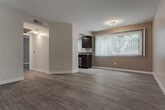 Located at 4620 S Slauson Ave in Los Angeles, California, this single-floor unit offers a clean, modern layout with a cohesive design throughout. Light wood-style flooring runs across the main living areas, complementing the neutral, warm-toned walls and white trim that give the space a bright, welcoming feel.

The open living and dining area is well-lit by a large window dressed with vertical blinds, allowing ample natural light to fill the room. A flush-mount ceiling light provides additional illumination, and the layout flows naturally toward the kitchen.

The kitchen is a standout feature, outfitted with rich dark espresso cabinetry, light stone-toned countertops, and a full suite of stainless steel appliances including a gas range, built-in microwave, and refrigerator. Track lighting overhead highlights the space, while a window above the sink brings in natural light. The generous counter space and cabinetry offer practical storage and prep areas.

The bedroom is a quiet, well-proportioned room with the same light flooring, a window with vertical blinds, and a ceiling vent for climate control.

The bathroom features a dark espresso vanity with a white countertop, a large mirror, a combined tub and shower, and a high transom window that provides ventilation and natural light while maintaining privacy.