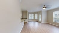 This 730 square foot apartment in Raleigh, NC offers a thoughtful layout maximizing space and functionality. The single-story unit features an open-concept design, seamlessly blending the kitchen, living, and dining areas. The kitchen boasts modern appliances, including a stainless steel refrigerator and range, complemented by white cabinetry and a spacious countertop with a sink and stylish faucet.

The 190 square foot bedroom provides ample space and is equipped with a ceiling fan and large windows, allowing natural light to flood the room. The bathroom features a single vanity with storage, a large mirror, and a shower/tub combination. Light wood-look flooring runs throughout the apartment, creating a cohesive and contemporary aesthetic.

Large windows in the living area and bedroom, fitted with horizontal blinds, offer views of the outdoors and control over light and privacy. Crown molding adds a touch of elegance to the space. The neutral color palette of the walls provides a versatile backdrop for various decor styles. A utility room offers additional storage and laundry facilities, enhancing the apartment's practicality and livability.