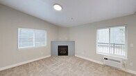 Located at 7531 NE 18th St in Vancouver, WA, this well-appointed 2-bedroom, 1-bathroom unit offers a practical and comfortable layout across a single floor. The inviting living room is a standout feature, showcasing a corner fireplace framed by neutral-toned walls, plush carpeting, and two windows that allow natural light to fill the space. The combined kitchen and dining area features wood-look flooring, white cabinetry, light gray countertops with a breakfast bar peninsula, and a full suite of stainless steel appliances including a refrigerator, range, and microwave. The two bedrooms are carpeted and well-sized, each offering closet storage, with the primary bedroom providing a generous footprint. The full bathroom is finished with wood-look tile flooring, a tub/shower combo, a gray countertop vanity, and clean white fixtures. A dedicated laundry room houses a full-size side-by-side washer and dryer. Additional highlights include a private balcony, a hallway connecting the bedrooms and bathroom, multiple closets for ample storage, and a welcoming entrance. The unit's consistent neutral palette and modern finishes create a cohesive, move-in-ready atmosphere throughout.