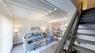Located at 901 St Johns Wood Drive in Richmond, VA, this two-story, 2-bedroom, 2-bathroom home offers a well-designed layout spread across two floors. The main level features a welcoming living and dining area anchored by striking exposed white-painted beam ceilings that add architectural character and a sense of openness. Hardwood-style flooring runs throughout the main level, complementing the neutral tones of the walls. Large sliding glass doors in both the living and dining areas flood the space with natural light and provide views of the lush greenery outside. A staircase with a sleek metal railing connects the two floors. The galley-style kitchen is well-appointed with white cabinetry, dark granite-style countertops, a tile backsplash, and stainless steel appliances. The dining area offers direct access to an outdoor patio. Upstairs, the generously sized primary bedroom features plush carpet, ample natural light from a window with outdoor views, and easy access to the adjoining bathroom. The second bedroom is equally comfortable, with soft carpet and a closet with sliding doors. Both bathrooms are functional and clean, featuring dark countertops and tub-shower combinations. The exterior is framed by mature trees, adding privacy and a serene natural setting.