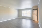 Located at 2112 Criston Dr in Newport News, Virginia, this single-floor home offers a well-designed layout with a thoughtful mix of flooring, finishes, and functional spaces throughout. The living area features durable luxury vinyl plank flooring in a warm gray tone, crown molding, and a large window that allows natural light to fill the room. Conveniently adjacent, a stacked washer and dryer unit is integrated into a dedicated laundry space with easy access to the kitchen. The kitchen is a standout feature, showcasing rich dark cabinetry, granite-style countertops, and a full suite of stainless steel appliances including a refrigerator, range, microwave, and dishwasher. A window above the sink brings in additional natural light, enhancing the space's functionality and appeal. The bedrooms are carpeted for comfort, with neutral tones and ample natural light from well-placed windows. The primary bedroom offers the added benefit of two closets, providing generous storage. Additional bedrooms each include their own closet space. The bathroom is finished with a dark wood vanity, granite-style countertop, and tiled surround. Throughout the home, clean lines, neutral color palettes, and updated finishes create a cohesive and move-in-ready environment.