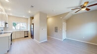 Located at 1750 Sunnyhills Dr in Milpitas, CA, this two-story, 2-bedroom, 1-bathroom unit is thoughtfully designed across two floors. The ground floor opens into a combined living and dining area featuring light hardwood-style flooring, warm neutral walls, a ceiling fan, and a glass door that leads to an outdoor space, filling the room with natural light. Adjacent is a well-appointed kitchen with white shaker cabinetry, white quartz countertops, stainless steel appliances including a refrigerator, dishwasher, and range, plus a window overlooking the exterior. A utility room and entrance area complete the lower level. Upstairs, the two carpeted bedrooms offer a comfortable retreat. The primary bedroom includes a walk-in closet, a ceiling fan, a wall-mounted mini-split HVAC unit, and a large window with neighborhood views. The second bedroom is equally bright, with its own closet and natural light. The shared full bathroom features a tub/shower combo, a white vanity with quartz countertop, and a window for natural ventilation. With multiple closets throughout and a practical layout, this unit delivers efficient and comfortable living in a clean, modern aesthetic.