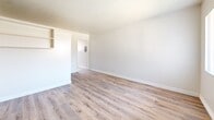 Located at 3635 Artesia Blvd in Torrance, California, this efficiently designed single-floor unit offers a practical layout comprising a living room, kitchen, and bathroom. Light wood-style flooring runs throughout the space, complementing the clean, neutral white walls and textured ceilings to create a bright and airy atmosphere.

The living room is an open, uncluttered area featuring a large window dressed with vertical blinds that allows natural light to fill the room. Built-in wall shelving provides convenient storage, and a front entry door offers direct access to the unit. The space is well-suited for flexible furniture arrangements.

The kitchen is neatly appointed with white cabinetry, a gas range with overhead ventilation, and a window that brings in additional natural light. The white appliances and cabinetry create a clean, cohesive look, while the wood-style flooring continues seamlessly from the main living area.

The bathroom stands out with elegantly tiled walls in a marble-effect pattern featuring warm veining, surrounding a full soaking tub. A small window above the tub allows for natural ventilation, while the wood-style flooring ties the room together with the rest of the unit.

Overall, this unit presents a clean, updated interior with consistent finishes, making it a functional and comfortable space in a well-established Torrance neighborhood.