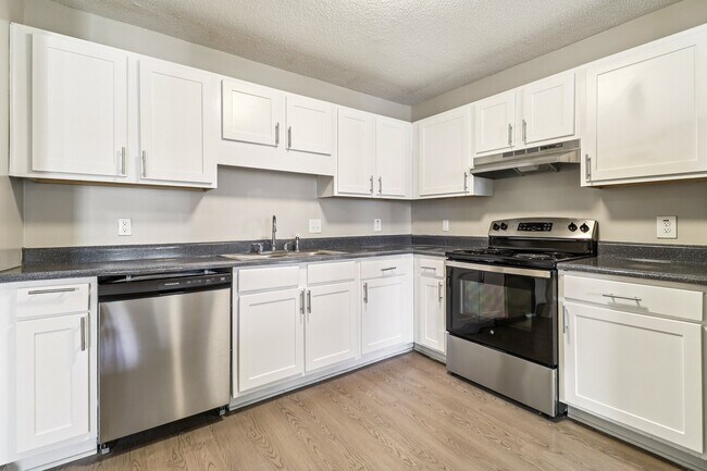 Prepare meals in style with white cabinets and quality stainless steel appliances, professionally operated by Highlands Vista Group. - Avalon Place