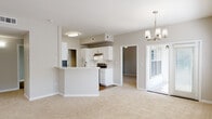 Located at 1510 Wimbledon Dr in Greenville, NC, this single-floor residence offers a well-designed layout with a cohesive, neutral color palette throughout. The open-concept living and dining area is generously proportioned, featuring plush wall-to-wall carpeting, multiple windows that invite abundant natural light, a ceiling fan, and an elegant chandelier that adds a refined touch to the space. Sliding glass doors provide convenient access to the outdoors.

The kitchen is thoughtfully designed with white cabinetry, a white quartz peninsula countertop, stainless steel appliances including a gas range and refrigerator, a tile backsplash, and an under-cabinet range hood. The peninsula opens directly to the living and dining areas, creating a seamless flow ideal for entertaining.

Each bedroom is carpeted and equipped with a ceiling fan for comfort. The bedrooms offer ample space and are serviced by walk-in and standard closets with built-in shelving. Natural light filters in through windows with blinds, enhancing the bright, airy feel of each room.

The bathrooms are finished with white vanities featuring brushed nickel hardware, large mirrors with modern light fixtures, white countertops, and wood-look flooring. Each bathroom includes a tub-shower combination, providing functional and clean design throughout.