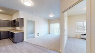Located at 2500 S Public Rd in Lafayette, CO, this single-floor residence offers four bedrooms and one bathroom within a thoughtfully arranged layout. The living area is bright and open, featuring plush carpeting, flush-mount ceiling lighting, and a sliding glass door dressed with vertical blinds that invites natural light and outdoor views. Light wood-look flooring transitions seamlessly from the entry and kitchen areas into the main living space.

The kitchen is designed in a U-shaped configuration, offering abundant dark-stained cabinetry, generous counter space, and a full suite of black appliances including a range, over-the-range microwave, refrigerator, and dishwasher. A tall pantry cabinet provides additional storage.

Each of the four bedrooms features soft carpeting, neutral warm-toned walls, and individual closets. Several bedrooms include large windows with vertical blinds, offering outdoor views and ample natural light. Ceiling fans are present in select rooms, and in-unit laundry hookups are accessible from one of the bedrooms.

The bathroom is ADA-accessible, equipped with stainless steel grab bars near the toilet, a vanity with dark cabinetry and a single sink, and light wood-look tile flooring. The overall design is clean, functional, and well-suited for comfortable everyday living.