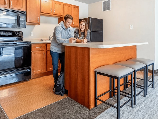 Modern kitchen featuring breakfast bar - The Element Student Housing