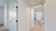Located at 1500 Cherry St in Placentia, CA, this thoughtfully designed residence offers 2 bedrooms, 3 bathrooms, and a well-utilized single-floor layout. Light wood-look flooring flows throughout the home, complemented by crisp white walls, recessed lighting, and clean modern finishes that create a bright, cohesive aesthetic.

The open-concept kitchen and living area serves as the heart of the home. The kitchen is outfitted with white shaker cabinetry, a geometric tile backsplash, quartz countertops, stainless steel appliances, and a central island with breakfast bar seating. The adjacent living area receives natural light through a large window and provides direct access to a private balcony.

The spacious primary bedroom features a ceiling fan, a mirrored sliding-door closet, and a dedicated en-suite bathroom complete with a white vanity, round mirror, matte black fixtures, and a walk-in shower. The second bedroom also includes a ceiling fan, a window with outdoor views, and generous closet space. A well-appointed full bathroom with a tub-shower combo serves the secondary bedroom and guests.

Additional highlights include two hallways for efficient circulation, a dedicated laundry room, and consistent modern hardware and finishes throughout. The overall ambiance is clean, contemporary, and move-in ready.