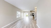 Located at 1929 Opal Street in Reynoldsburg, Ohio, this two-story, three-bedroom, two-bathroom home offers a well-designed layout across two floors. The main level features a bright, open living area with light hardwood-style flooring and large windows that invite abundant natural light. The kitchen is outfitted with white shaker cabinetry, dark granite countertops, a subway tile backsplash, and a full suite of stainless steel appliances, including a range, microwave, dishwasher, and refrigerator. A peninsula with additional counter space enhances both functionality and flow. The main level also includes an attached garage with an automatic opener, providing convenient interior access. Upstairs, three carpeted bedrooms offer a comfortable retreat, including a generously sized primary bedroom with vaulted ceilings, a ceiling fan, and a window with outdoor views. The two bathrooms are finished consistently with white cabinetry and dark granite countertops — one featuring a tub/shower combo with a framed mirror, and the other a walk-in glass-door shower with a window for natural light. Neutral warm-toned walls and light flooring throughout create a cohesive, move-in-ready aesthetic.