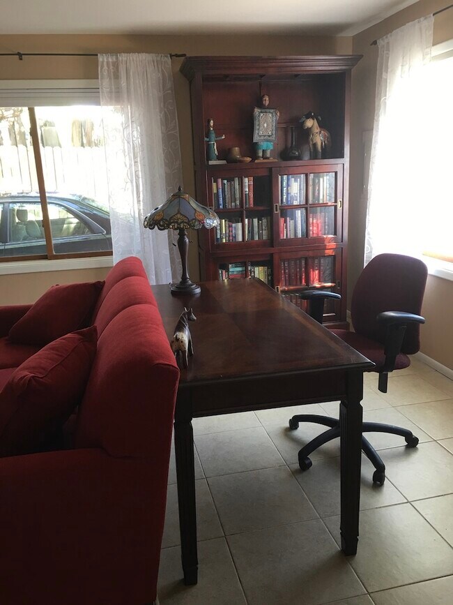 Sala de estar con escritorio de computadora y estantería - 2308 Cedros Cir