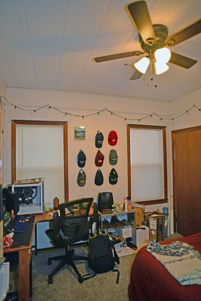 Main floor bedroom with ceiling fan. - 103 Warwick St SE