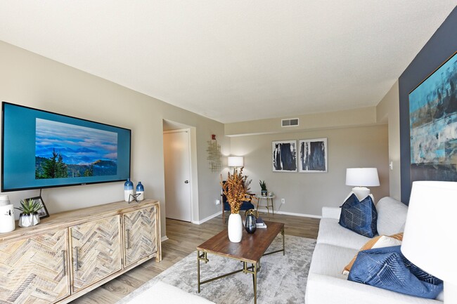 Spacious living room with hardwood-style flooring - Ivy at West Hills