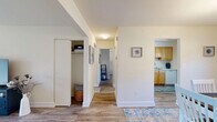 Located at 3601 Yennar Ln in Windsor Mill, MD, this well-maintained 2-bedroom, 1-bathroom single-floor home offers a comfortable and functional layout throughout. Hardwood-style flooring flows consistently across the living spaces, lending a clean and cohesive aesthetic.

The living room is a welcoming focal point, filled with natural light and featuring sliding glass doors that open to an outdoor patio, offering pleasant views of the surrounding greenery. The adjacent dining room is illuminated by a classic chandelier and benefits from multiple windows, creating a bright and inviting space for meals. The kitchen is equipped with warm honey-toned cabinetry, ample counter space, and full appliances including a gas range, built-in microwave, and dishwasher.

The spacious primary bedroom features two closets and a large window that allows generous natural light to fill the room. The second bedroom is a comfortable, well-lit space with its own closet and window. The single bathroom is thoughtfully finished with white shiplap-style wall paneling, a wood-toned vanity, and a window for natural ventilation. A hallway and dedicated closet round out the home's practical layout, offering convenient storage throughout.