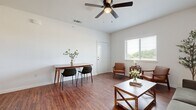 This efficient yet thoughtfully designed 1-bedroom, 1-bathroom unit offers a comfortable and functional layout across a single floor. Rich hardwood-style flooring flows consistently throughout the space, providing a warm and cohesive aesthetic.

The combined kitchen and living area forms the heart of the unit. The living space is bright and airy, featuring elevated ceilings, a ceiling fan with light fixture, and a large window that invites natural light and outdoor views. The kitchen is well-appointed with warm wood cabinetry, stainless steel appliances, granite countertops, and a breakfast bar with seating for two — ideal for casual dining or entertaining.

The bedroom is a comfortable retreat, featuring a window with outdoor views, generous natural light, and ample space for a full-sized bed and additional furnishings. A dedicated closet provides convenient storage.

The bathroom includes a granite-topped wood vanity, full bathtub with shower, and matching hardwood-style flooring for a consistent design feel throughout. A dedicated laundry area houses a full-sized top-loading washer and dryer, adding everyday convenience.

Overall, the unit presents a clean, modern aesthetic with neutral tones, warm wood accents, and practical finishes that create an inviting and functional living environment.