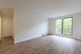 This well-appointed one-bedroom, one-bathroom unit at 420 Central Ave in London, Ontario offers a clean, modern aesthetic throughout. Light-toned hardwood-style flooring flows seamlessly across the entire space, complementing the crisp white walls and creating a bright, cohesive feel.

The open-concept kitchen and living area is a functional centerpiece of the unit. The kitchen is outfitted with white shaker-style cabinetry, a classic subway tile backsplash, dark countertops, and a full suite of stainless steel appliances including a range, microwave, and dishwasher. The living room benefits from large sliding glass doors that open to a private balcony, flooding the space with natural light and offering pleasant views of surrounding greenery.

The bedroom is a comfortable and well-lit retreat, featuring a window with tree-lined views, a built-in double closet for ample storage, and baseboard heating. The bathroom is finished in a clean, contemporary style with a white vanity, undermount sink, chrome fixtures, and a well-lit mirror. Baseboard heating is present throughout the unit, ensuring year-round comfort. The overall ambiance is light, airy, and move-in ready, with thoughtful modern finishes that make efficient use of the available space.