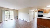 Located at 1068 Todd Farm Dr in Elgin, IL, this well-appointed 3-bedroom, 2-bathroom home offers a thoughtfully designed single-floor layout. The open living room is bright and inviting, featuring warm hardwood-style flooring, neutral walls, and a sliding glass door that leads to a private balcony with outdoor views — an ideal spot for relaxing or entertaining.

The kitchen is efficiently laid out and equipped with warm-toned wood cabinetry, black appliances including a range, microwave, dishwasher, and refrigerator, complemented by light quartz-style countertops and a tile backsplash. A breakfast bar provides additional prep and dining space.

The generously sized primary bedroom features plush carpeting, a large closet with classic panel doors, a window allowing natural light, and a wall-mounted AC unit. The additional bedrooms are also carpeted, offering comfortable, quiet retreats.

Both bathrooms are clean and functional, featuring tiled tub-shower combinations, vanities with wood cabinetry, and light tile flooring. The overall design is cohesive throughout, with a neutral color palette and practical finishes that complement the home's functional floor plan.
