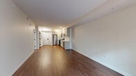 Located at 111 N Madison Ave in Pasadena, CA, this well-appointed one-bedroom, one-bathroom unit offers a thoughtfully designed single-floor layout. The open-concept living and kitchen area serves as the heart of the home, showcasing warm hardwood-style flooring that extends throughout the main living spaces. The kitchen is outfitted with a full suite of stainless steel appliances — including a refrigerator, gas range, microwave, and dishwasher — complemented by grey shaker-style cabinetry, white quartz countertops, and a classic white subway tile backsplash. Recessed lighting adds a clean, modern touch. A dedicated hallway leads to the private bedroom, which features plush carpeting and a window with views of greenery, allowing natural light to fill the room. A closet provides convenient storage. The bathroom includes a full soaking tub with floor-to-ceiling white tile surround. A notable practical feature is the in-unit stacked washer and dryer, tucked neatly into a dedicated closet space near the entryway. Neutral tones and clean finishes throughout give the unit a bright, move-in-ready ambiance suited for comfortable urban living in the heart of Pasadena.