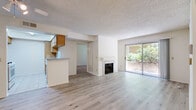 Located in the Woodland Hills neighborhood of Los Angeles, this 2-bedroom, 2-bathroom single-floor home offers a practical and comfortable layout. The open living area is anchored by a tiled fireplace and light wood laminate flooring, creating a warm and inviting atmosphere. A sliding glass door floods the space with natural light and provides direct access to a private outdoor patio surrounded by lush greenery. A ceiling fan adds to the comfort of the living room.

The kitchen features warm wood cabinetry, light countertops, tile flooring, and a peninsula that opens to the living area, making it well-suited for both everyday living and entertaining. White appliances, including a microwave and stovetop, are neatly integrated into the cabinetry.

Both bedrooms are carpeted and offer a quiet, restful feel. The spacious primary bedroom benefits from natural light through a dedicated window, while the second bedroom is similarly well-proportioned. Both bathrooms are finished in neutral tones and include a tub-shower combination with sliding glass enclosures and tile flooring. Textured ceilings are consistent throughout the home, adding a classic architectural touch to each room.