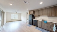 Located at 4025 Salisbury Rd in Jacksonville, FL, this single-floor, 2-bedroom, 2-bathroom residence offers a practical and modern layout designed for comfortable everyday living. The open-concept living, dining, and kitchen area forms the heart of the home, featuring light wood-style flooring, recessed lighting, and a ceiling fan that enhances airflow throughout the space. Natural light filters in through blinds-fitted windows, creating a bright and welcoming atmosphere.

The kitchen is equipped with warm-toned wood cabinetry, white countertops, a black refrigerator, dishwasher, and range, alongside a sink with ample counter space — all flowing seamlessly into the living and dining area.

Both bedrooms are carpeted and include ceiling fans and windows that bring in natural light. The primary bedroom features direct access to its own bathroom and a walk-in closet with wire shelving for organized storage. The second bedroom also benefits from its own walk-in closet. Each bathroom includes wood-toned vanity cabinetry, white countertops, and a shower. Additional conveniences include a dedicated laundry area, completing this efficiently designed, move-in-ready residence.